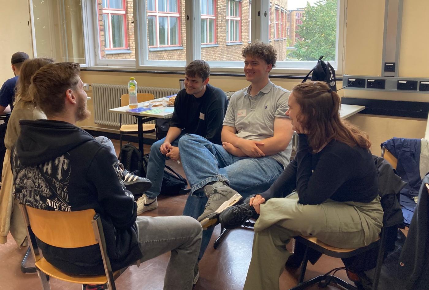 Deutsche Gesellschaft e. V., Jugenliche sitzen in Gruppe zusammen im Übungsraum